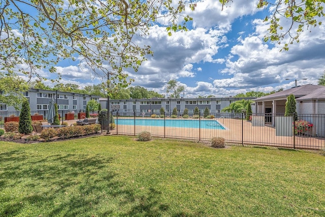 view of pool with a lawn