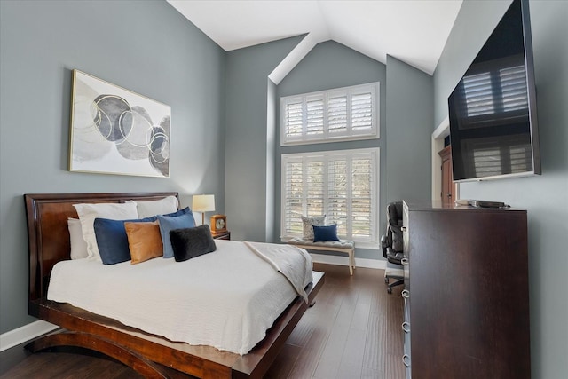 bedroom featuring dark hardwood / wood-style flooring and lofted ceiling