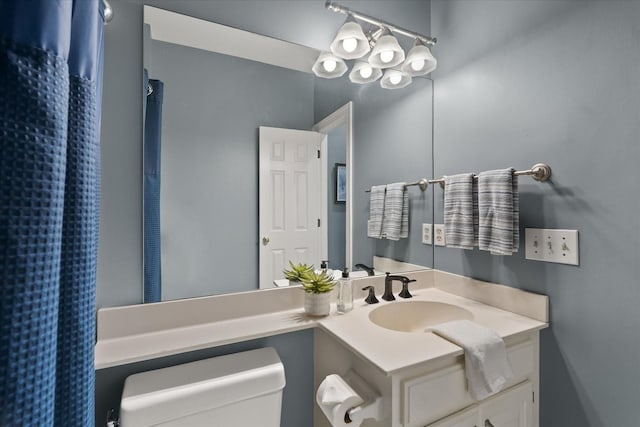 bathroom featuring vanity and toilet