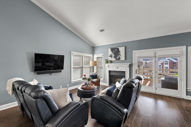 living room with ornamental molding, dark wood-type flooring, and vaulted ceiling