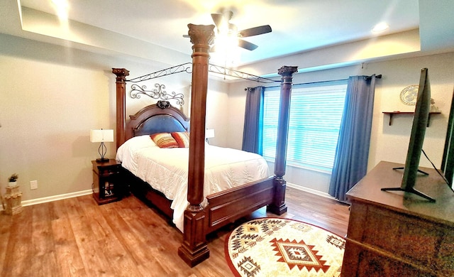 bedroom with ceiling fan and hardwood / wood-style flooring