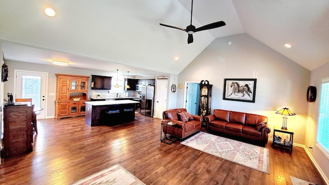 living room featuring lofted ceiling, ceiling fan, and dark hardwood / wood-style flooring