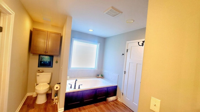 bathroom featuring a bathtub, wood-type flooring, and toilet