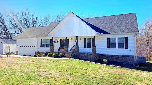 view of front of house with central AC unit, a front lawn, a garage, and covered porch