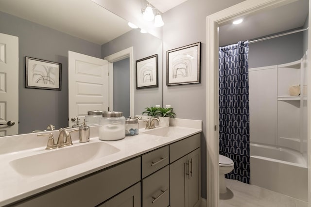 full bathroom with tile patterned floors, shower / bath combo with shower curtain, vanity, and toilet