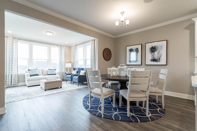 dining area featuring dark wood-type flooring, a notable chandelier, and ornamental molding