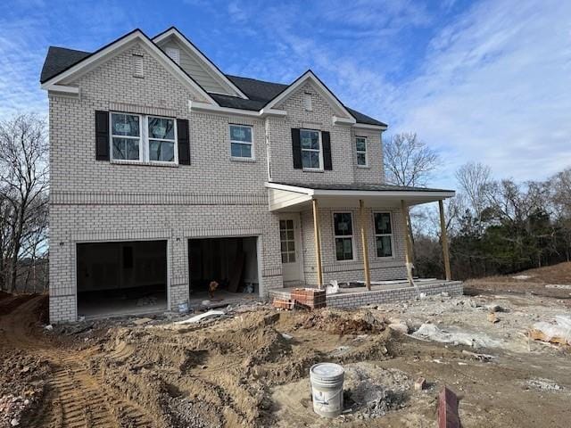 view of front facade with a porch and a garage