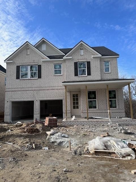 view of front of property with a porch and a garage