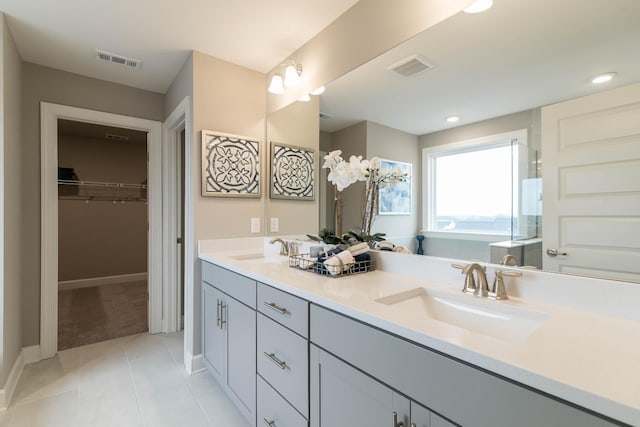 bathroom with tile patterned floors, vanity, and a bath