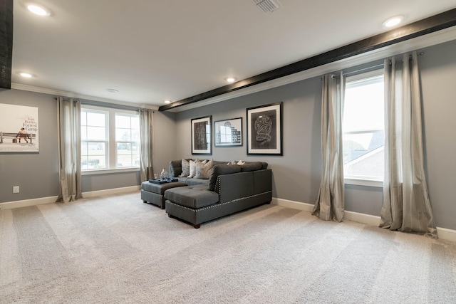 carpeted living room with ornamental molding