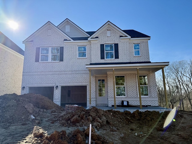 view of front of house with a porch and a garage