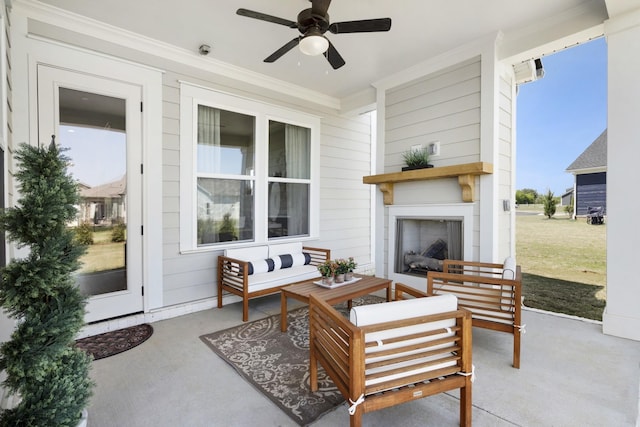 view of patio featuring ceiling fan and an outdoor living space with a fireplace