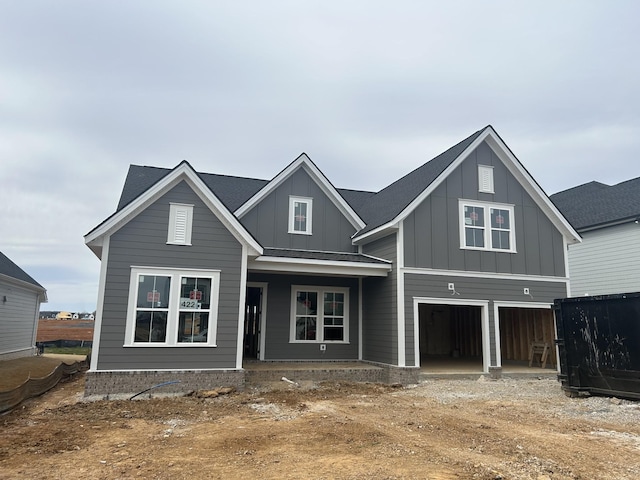 view of front facade featuring a garage, board and batten siding, and driveway