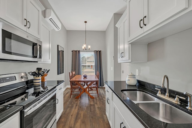 kitchen featuring white cabinetry, appliances with stainless steel finishes, sink, and a wall mounted air conditioner