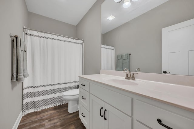 bathroom with vanity, toilet, and wood-type flooring