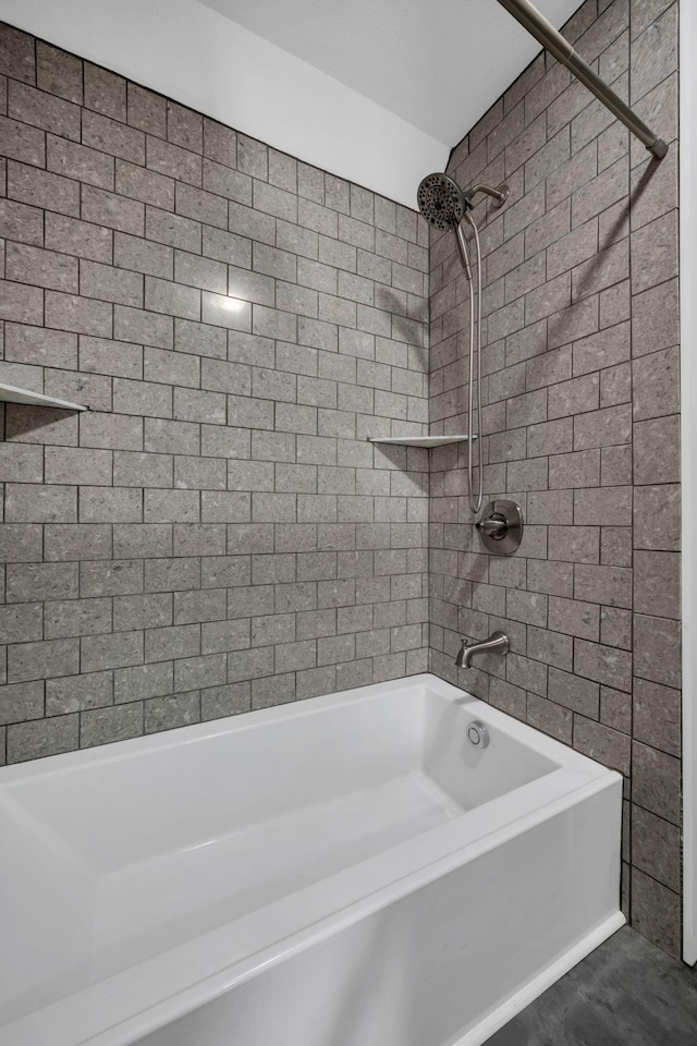 bathroom with wood-type flooring and tiled shower / bath combo