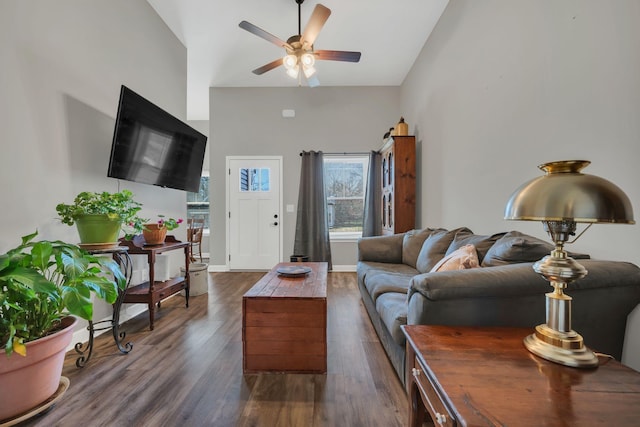 living room featuring ceiling fan and dark hardwood / wood-style flooring