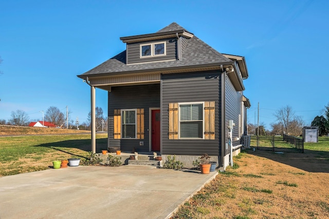 view of front of house with a patio, central AC, and a front lawn