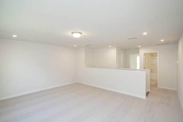 spare room featuring light colored carpet