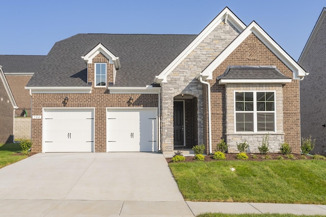 view of front of house featuring a garage and a front lawn