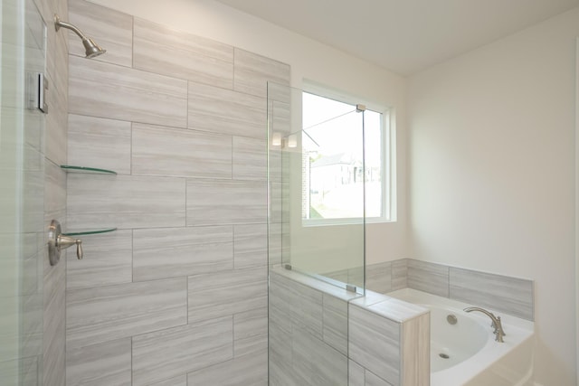 bathroom featuring separate shower and tub