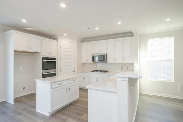 kitchen with white cabinets, a kitchen island, and stainless steel appliances