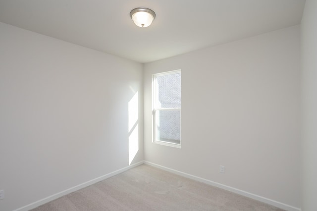 empty room featuring a wealth of natural light and light colored carpet