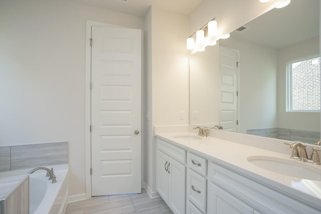 bathroom featuring a tub and vanity