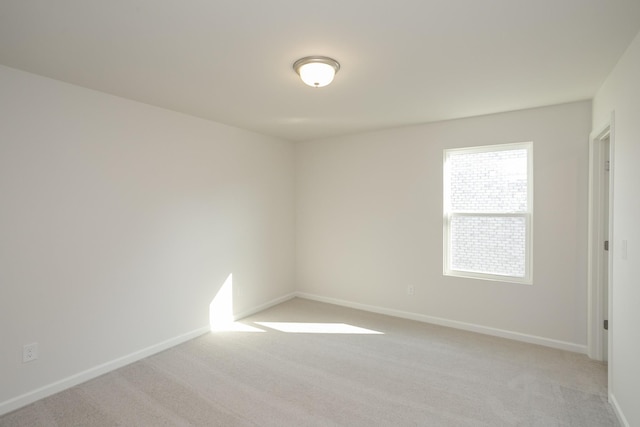 unfurnished room featuring light colored carpet