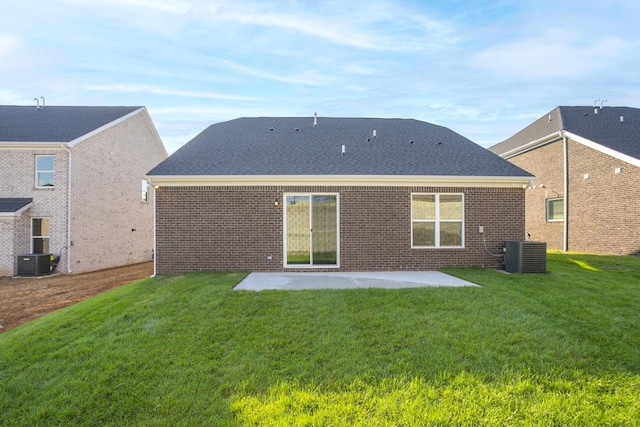 back of property with cooling unit, a patio area, and a lawn