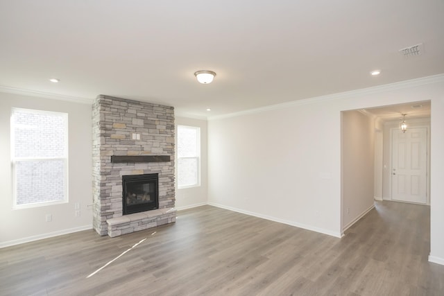 unfurnished living room with crown molding, a fireplace, and wood-type flooring