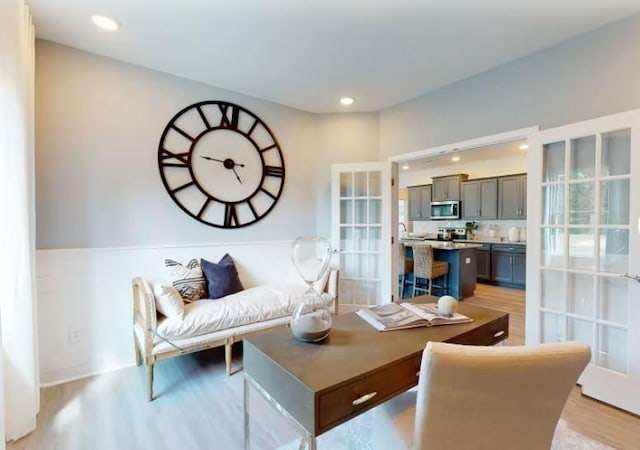 living room with light hardwood / wood-style floors and french doors