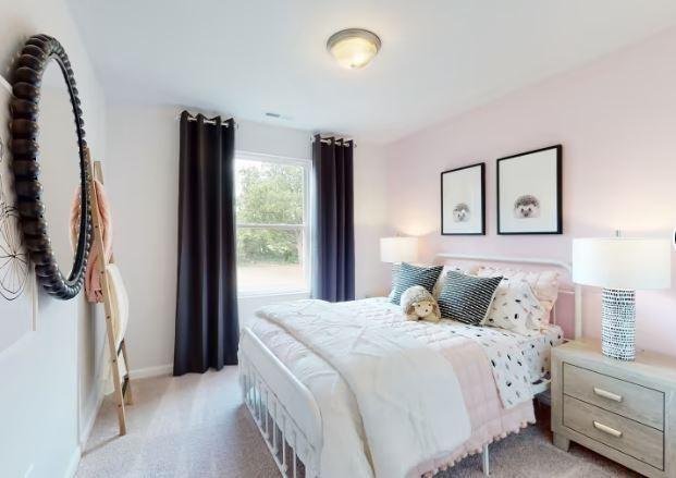 bedroom featuring light carpet