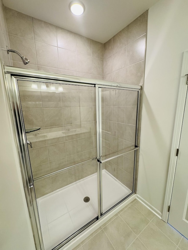 bathroom featuring tile patterned flooring and a shower with door