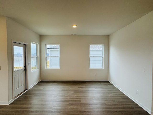 spare room featuring dark wood-type flooring