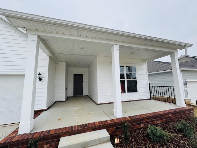 property entrance featuring a porch and a garage