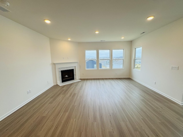 unfurnished living room with hardwood / wood-style flooring