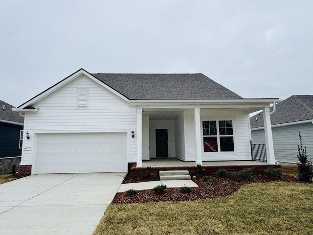 view of front facade with a garage, a front yard, and covered porch