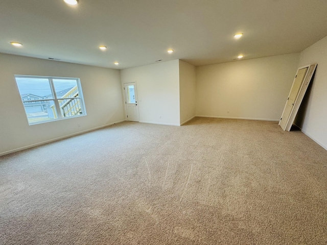 unfurnished room featuring light carpet