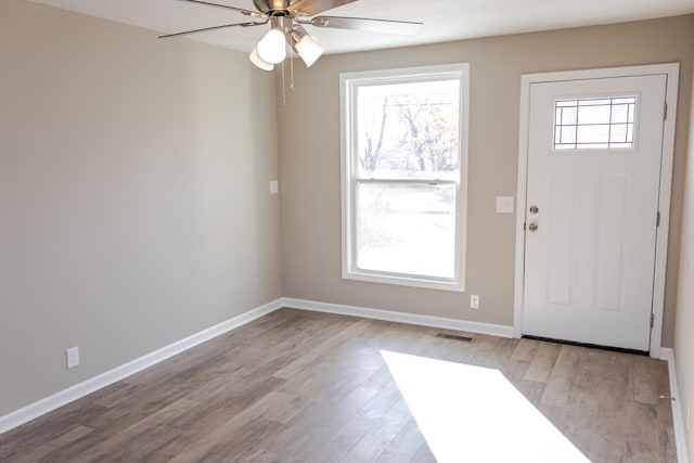 foyer entrance with ceiling fan, light wood-type flooring, and a wealth of natural light