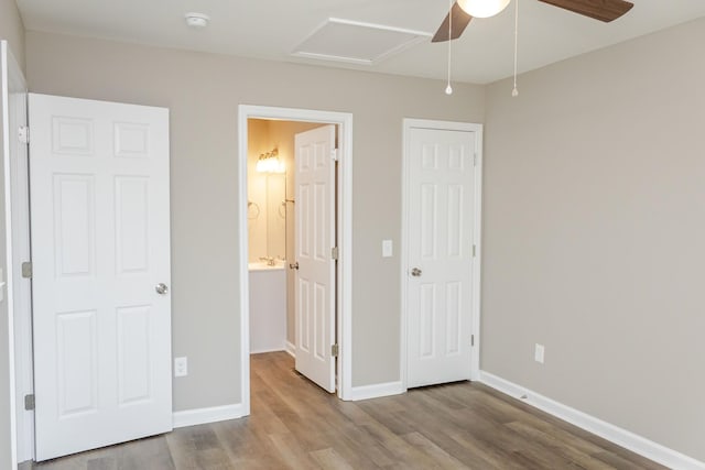 unfurnished bedroom with ceiling fan, connected bathroom, and light hardwood / wood-style flooring