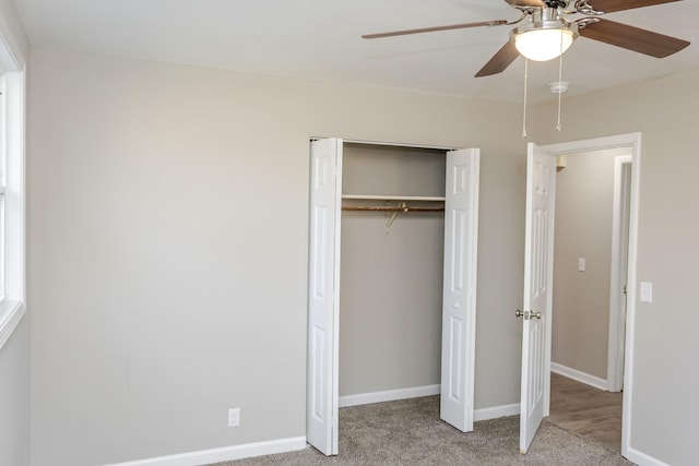 unfurnished bedroom with carpet floors, a closet, and ceiling fan