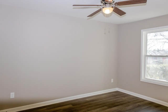 spare room featuring ceiling fan and dark wood-type flooring