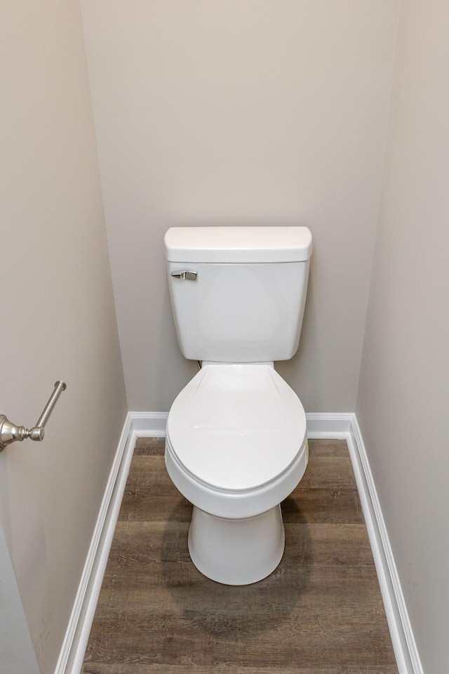 bathroom with toilet and wood-type flooring