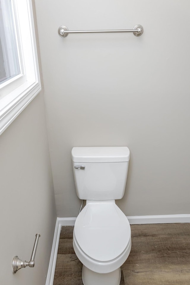 bathroom with hardwood / wood-style flooring and toilet