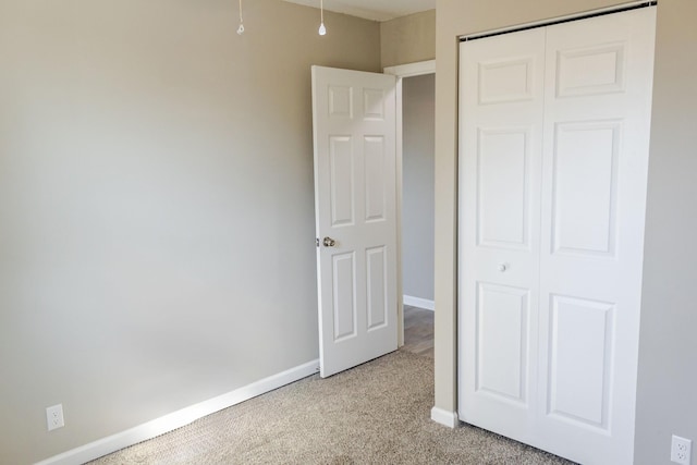 unfurnished bedroom featuring a closet and carpet floors