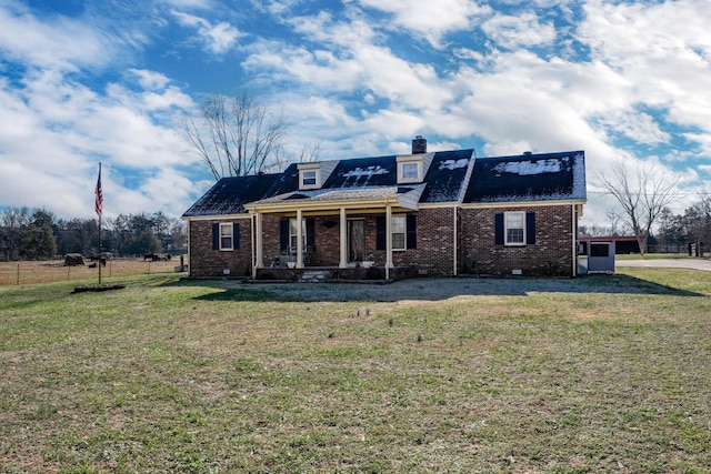 cape cod home featuring covered porch and a front yard