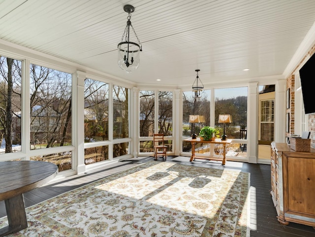 sunroom with a wealth of natural light and a notable chandelier