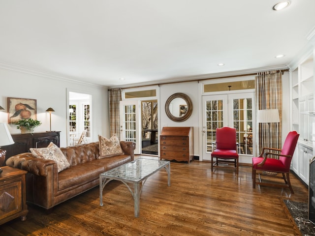 living room with ornamental molding, dark wood-type flooring, and french doors