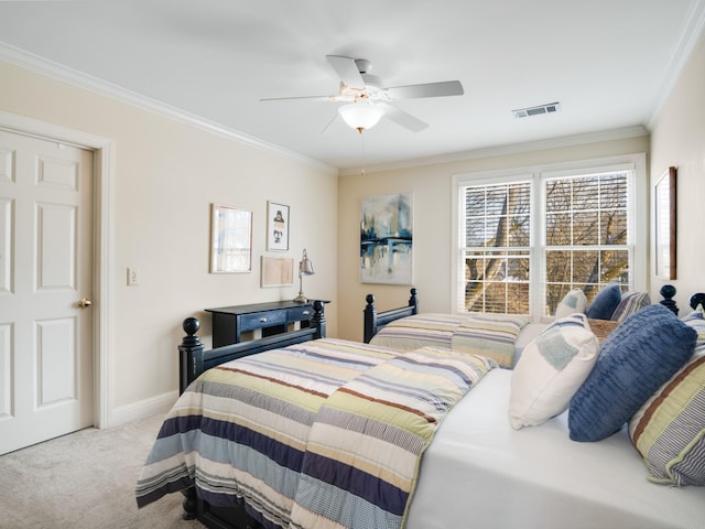 carpeted bedroom with ceiling fan and crown molding